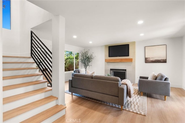 20371 Allport Ln, Huntington Beach, CA 92646 - living room with a large fireplace, wood finished floors, recessed lighting, and stairway