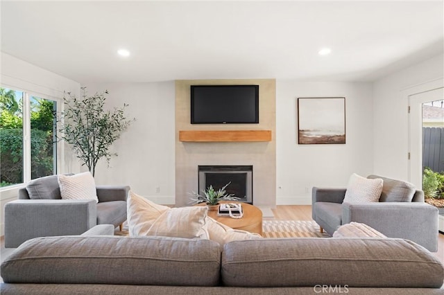 20371 Allport Ln, Huntington Beach, CA 92646 - living room featuring healthy amount of natural light, recessed lighting, light wood-type flooring, and a large fireplace