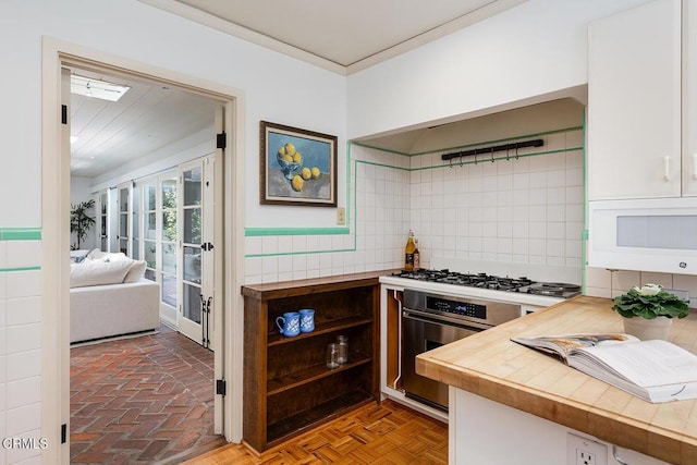 314 Arroyo Dr, South Pasadena, CA 91030 - kitchen featuring stainless steel appliances, crown molding, white cabinets, and decorative backsplash