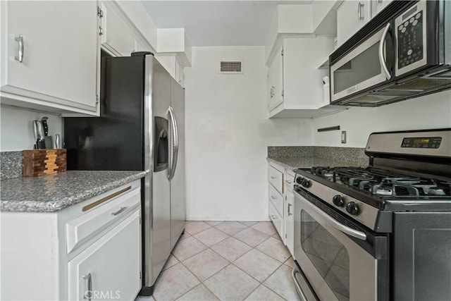 1525 N Hayworth Ave Unit 205, Los Angeles, CA 90046 - kitchen with appliances with stainless steel finishes, white cabinetry, and light tile patterned floors
