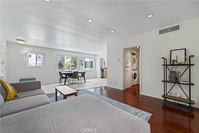 1525 N Hayworth Ave Unit 205, Los Angeles, CA 90046 - living room with stacked washer and clothes dryer, wood finished floors, and recessed lighting