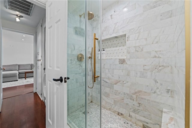 1525 N Hayworth Ave Unit 205, Los Angeles, CA 90046 - bathroom featuring tiled shower, wood finished floors, and ensuite bath