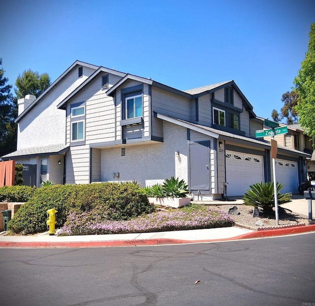 5312 Caminito Cachorro, San Diego, CA 92105 - view of front of property with a garage, stucco siding, and a chimney