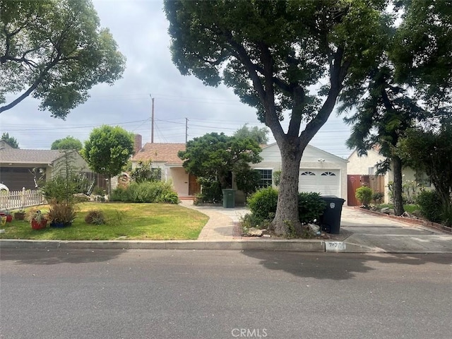 717 N Valley St, Toluca Lake, CA 91505 - view of front of house featuring driveway and a garage
