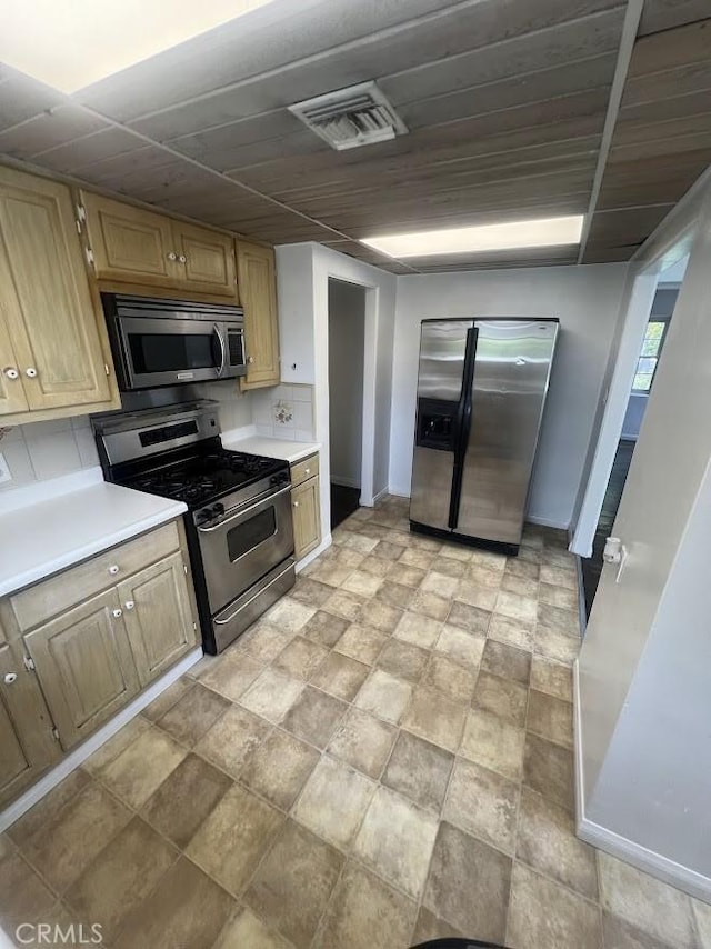 717 N Valley St, Toluca Lake, CA 91505 - kitchen featuring stainless steel appliances, light countertops, and stone finish flooring