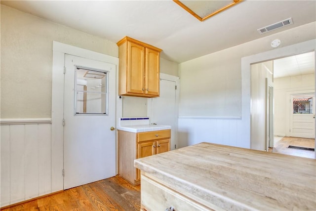 128 N Mason St, Arroyo Grande, CA 93420 - kitchen featuring light countertops, wood finished floors, and wainscoting