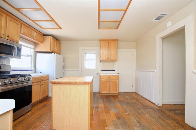128 N Mason St, Arroyo Grande, CA 93420 - kitchen with stainless steel appliances, light brown cabinets, a wainscoted wall, butcher block counters, and wood finished floors