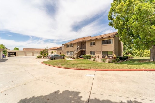 17430 Plaza Otonal, San Diego, CA 92128 - view of front of home with stucco siding, a front yard, a tiled roof, and a detached garage