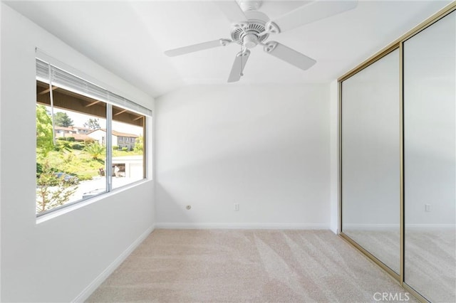 17430 Plaza Otonal, San Diego, CA 92128 - unfurnished bedroom with a closet, light carpet, a ceiling fan, and vaulted ceiling
