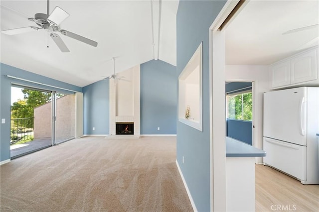 17430 Plaza Otonal, San Diego, CA 92128 - unfurnished living room featuring lofted ceiling, ceiling fan, a brick fireplace, and light carpet