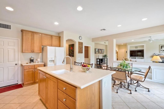 118 Double Eagle, Escondido, CA 92026 - kitchen featuring white refrigerator with ice dispenser, light countertops, light tile patterned floors, a center island with sink, and recessed lighting