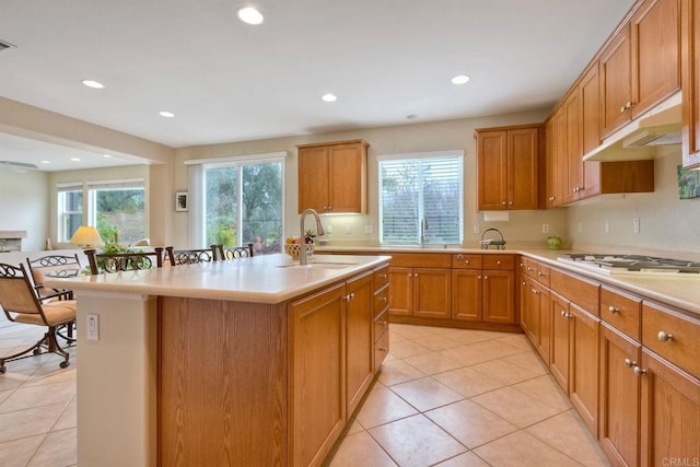 118 Double Eagle, Escondido, CA 92026 - kitchen with under cabinet range hood, plenty of natural light, light countertops, a kitchen island with sink, and recessed lighting
