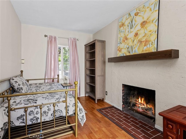 334 N Lomita St, Burbank, CA 91506 - bedroom with wood finished floors and a fireplace with flush hearth