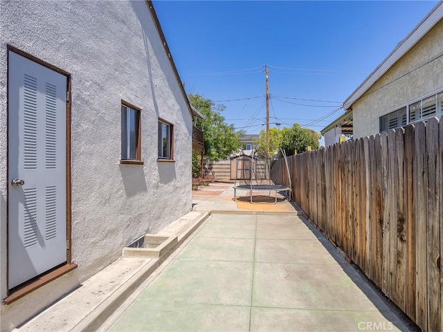 334 N Lomita St, Burbank, CA 91506 - fenced backyard featuring a trampoline, a patio area, and a shed