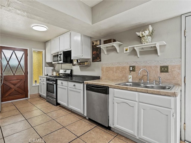 334 N Lomita St, Burbank, CA 91506 - kitchen with appliances with stainless steel finishes, open shelves, white cabinetry, and light tile patterned floors