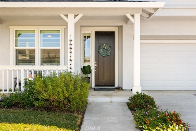 27 Bentwater Loop, Chico, CA 95973 - property entrance with covered porch, driveway, a garage, and stucco siding