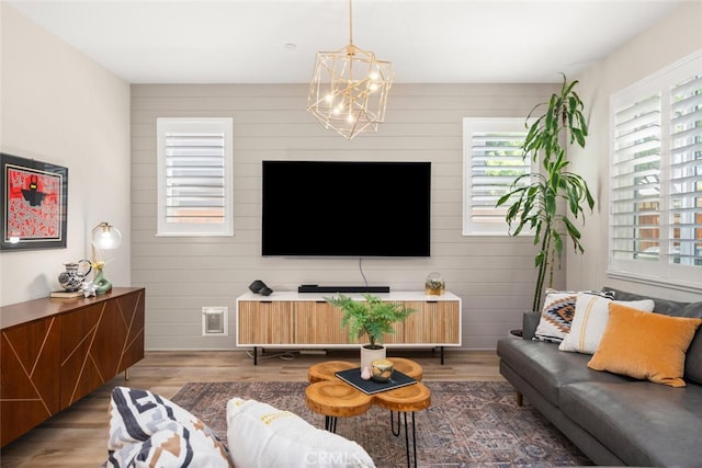 27 Bentwater Loop, Chico, CA 95973 - living area featuring a chandelier, wood finished floors, and wood walls