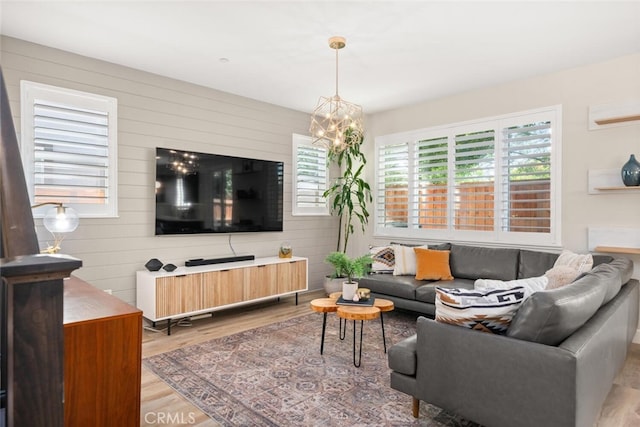 27 Bentwater Loop, Chico, CA 95973 - living room featuring wood finished floors, a chandelier, and wood walls