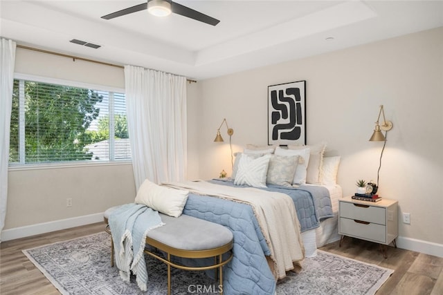 27 Bentwater Loop, Chico, CA 95973 - bedroom featuring wood finished floors, a raised ceiling, and a ceiling fan