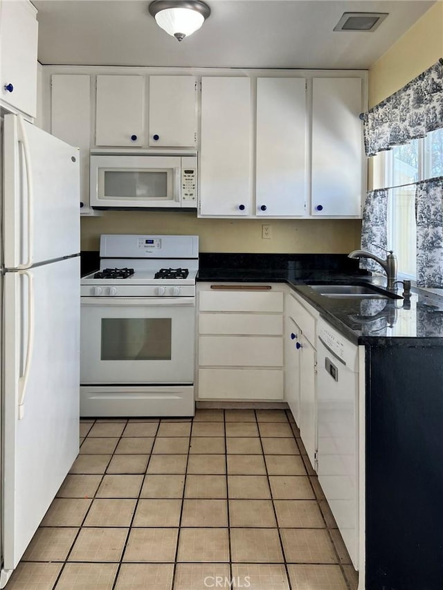 18 Fairside Unit 30, Irvine, CA 92614 - kitchen with white appliances, dark countertops, white cabinets, and light tile patterned floors