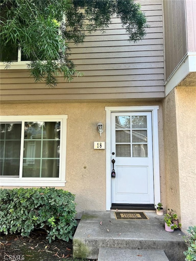 18 Fairside Unit 30, Irvine, CA 92614 - doorway to property featuring stucco siding