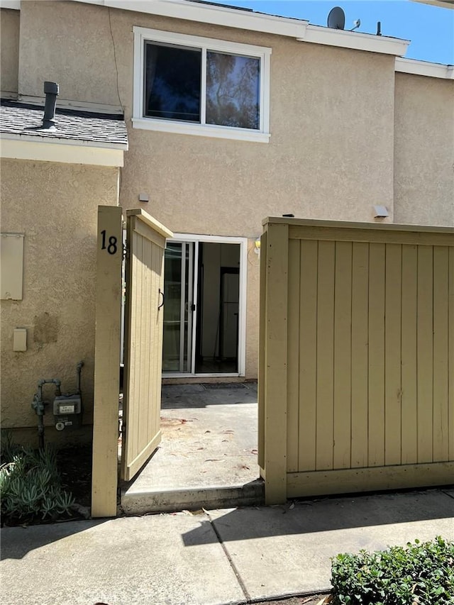 18 Fairside Unit 30, Irvine, CA 92614 - back of property with stucco siding and a patio