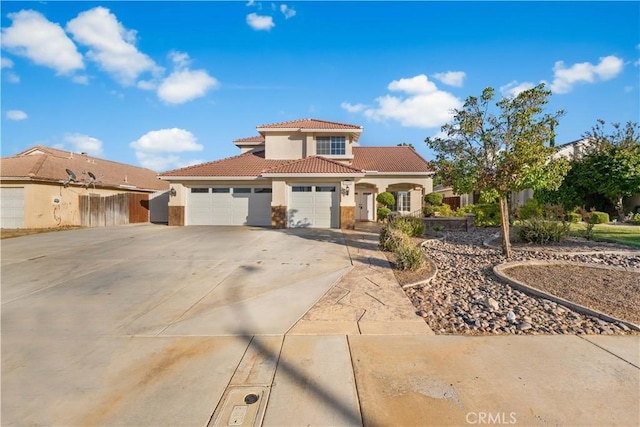 2892 Chuckwagon Rd, Palmdale, CA 93550 - mediterranean / spanish-style home with stucco siding, a tile roof, concrete driveway, and a garage