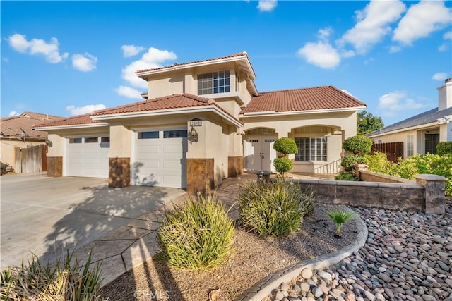 2892 Chuckwagon Rd, Palmdale, CA 93550 - mediterranean / spanish-style house with stucco siding, an attached garage, driveway, and a tiled roof