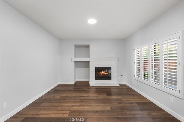 2892 Chuckwagon Rd, Palmdale, CA 93550 - unfurnished living room featuring a fireplace, dark wood-style floors, and recessed lighting