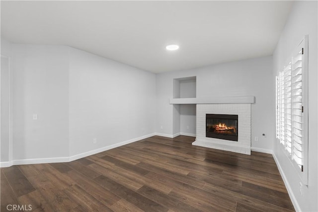 2892 Chuckwagon Rd, Palmdale, CA 93550 - unfurnished living room featuring a fireplace, dark wood finished floors, and recessed lighting