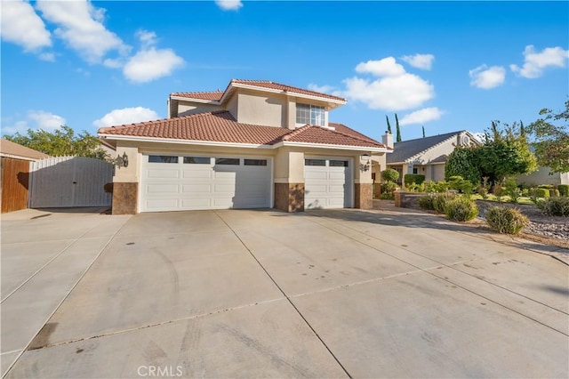 2892 Chuckwagon Rd, Palmdale, CA 93550 - mediterranean / spanish-style home with stucco siding, a gate, a garage, driveway, and a tile roof