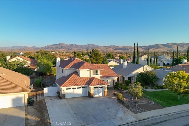 2892 Chuckwagon Rd, Palmdale, CA 93550 - view of front of property with a tiled roof, a gate, stucco siding, an attached garage, and a residential view