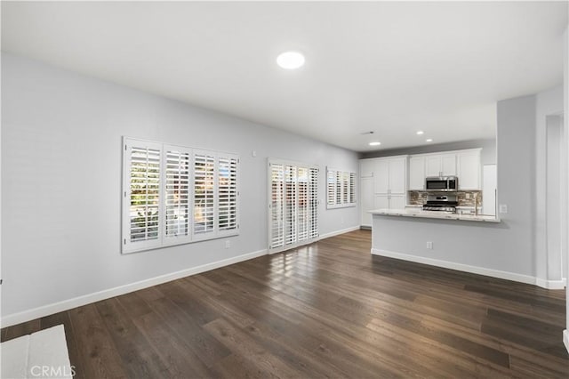 2892 Chuckwagon Rd, Palmdale, CA 93550 - unfurnished living room with healthy amount of natural light, dark wood-style flooring, and recessed lighting