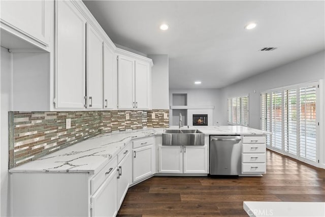 2892 Chuckwagon Rd, Palmdale, CA 93550 - kitchen with dishwasher, a peninsula, white cabinets, decorative backsplash, and dark wood finished floors