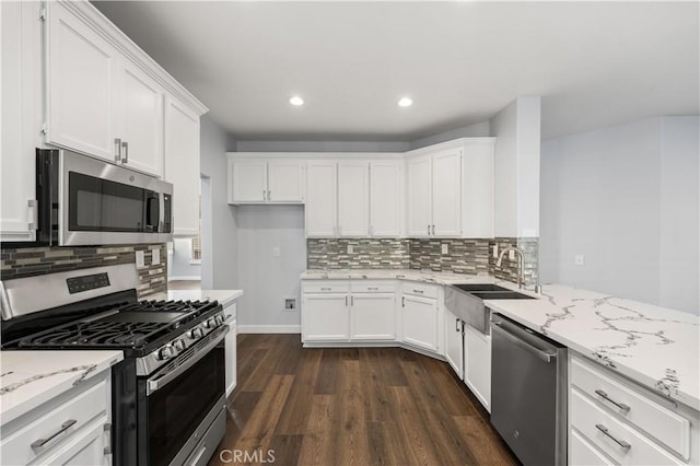 2892 Chuckwagon Rd, Palmdale, CA 93550 - kitchen featuring stainless steel appliances, dark wood-style floors, white cabinetry, light stone counters, and recessed lighting