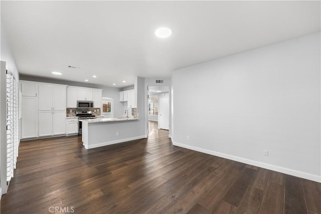 2892 Chuckwagon Rd, Palmdale, CA 93550 - unfurnished living room with dark wood-style floors and recessed lighting