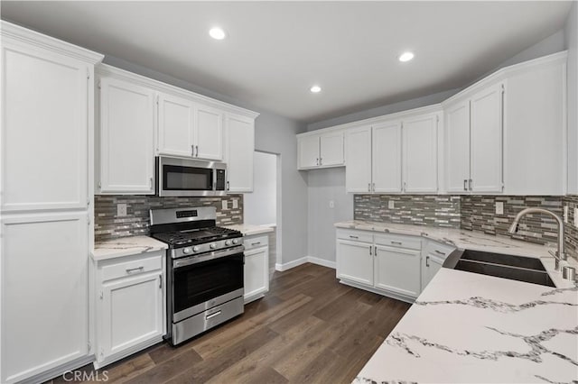 2892 Chuckwagon Rd, Palmdale, CA 93550 - kitchen with stainless steel appliances, white cabinetry, light stone counters, tasteful backsplash, and recessed lighting
