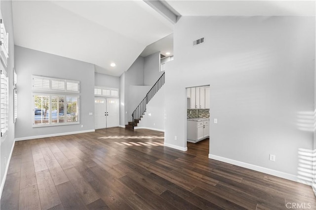 2892 Chuckwagon Rd, Palmdale, CA 93550 - unfurnished living room featuring high vaulted ceiling, dark wood-style flooring, stairs, and beamed ceiling