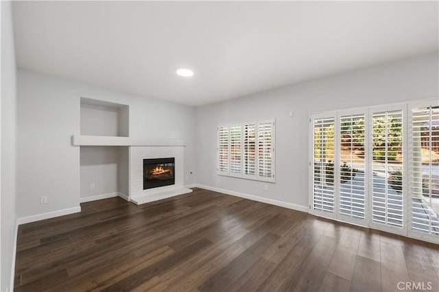 2892 Chuckwagon Rd, Palmdale, CA 93550 - unfurnished living room featuring wood finished floors, a brick fireplace, and recessed lighting