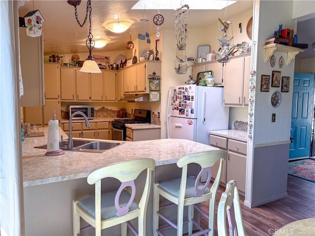 27545 Jasper Way, Castaic, CA 91384 - kitchen with freestanding refrigerator, gas stove, wood finished floors, and light countertops