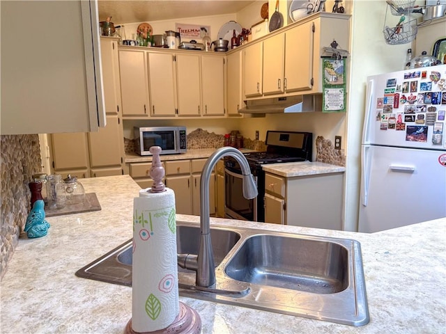 27545 Jasper Way, Castaic, CA 91384 - kitchen with appliances with stainless steel finishes, under cabinet range hood, light countertops, and cream cabinets