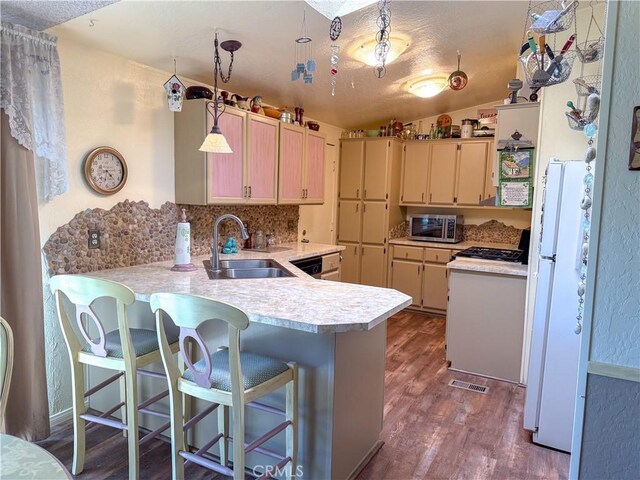 27545 Jasper Way, Castaic, CA 91384 - kitchen featuring freestanding refrigerator, light countertops, stainless steel microwave, a peninsula, and dark wood finished floors