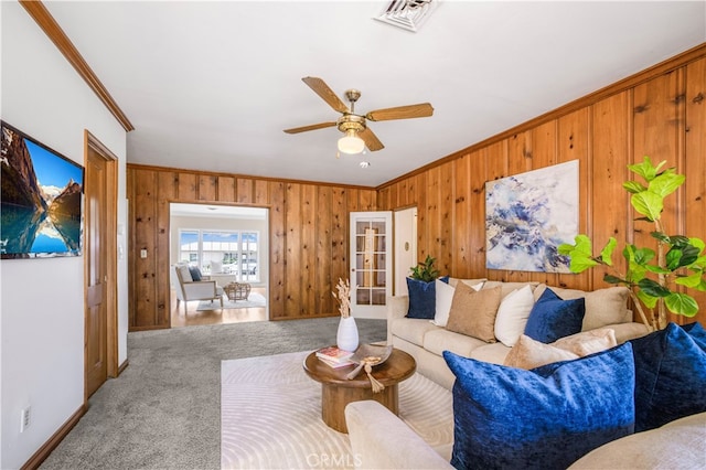 695 W 13th St, Upland, CA 91786 - carpeted living area with ornamental molding, wooden walls, and a ceiling fan