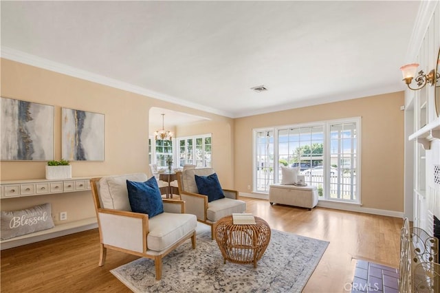 695 W 13th St, Upland, CA 91786 - living area with a chandelier, wood finished floors, and ornamental molding
