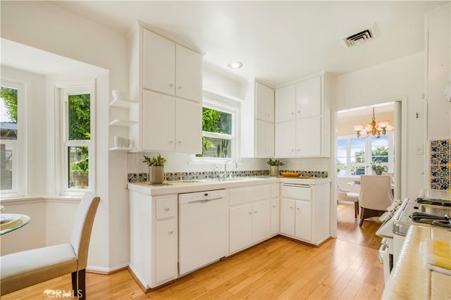 695 W 13th St, Upland, CA 91786 - kitchen featuring white appliances, light wood finished floors, a chandelier, tasteful backsplash, and light countertops