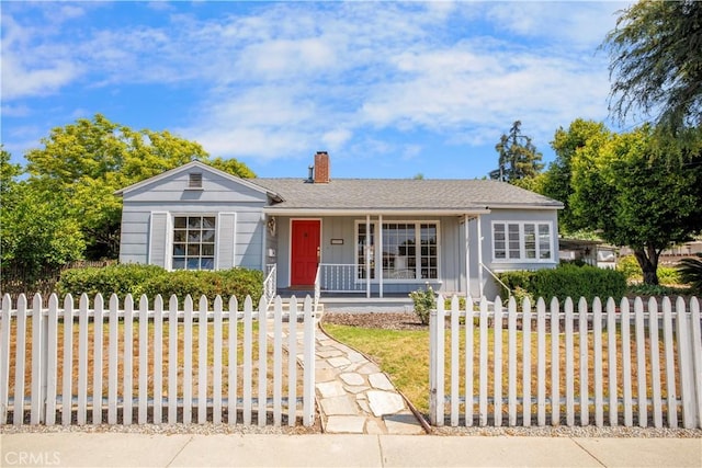695 W 13th St, Upland, CA 91786 - ranch-style home with a porch, a chimney, board and batten siding, and a fenced front yard