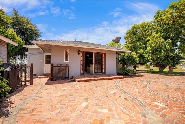 695 W 13th St, Upland, CA 91786 - back of house featuring stucco siding and a gate