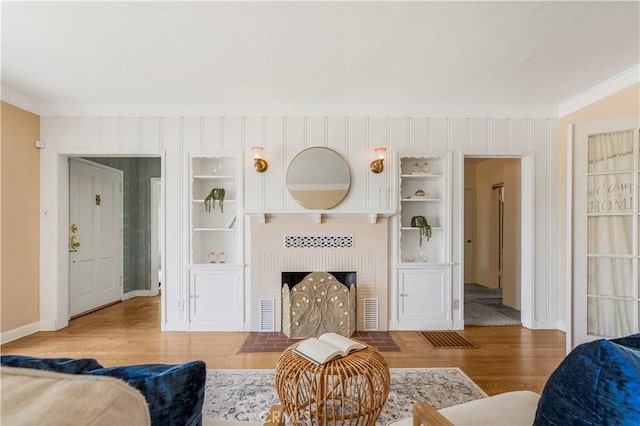 695 W 13th St, Upland, CA 91786 - living area with crown molding, wood finished floors, and a brick fireplace