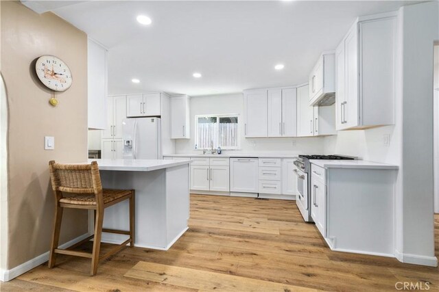 4955 Arizona Ave, Atascadero, CA 93422 - kitchen with white appliances, light wood-style floors, white cabinetry, light countertops, and recessed lighting