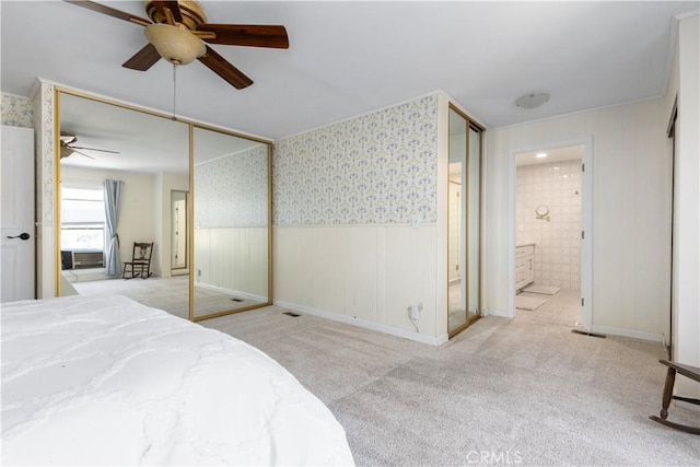 4955 Arizona Ave, Atascadero, CA 93422 - carpeted bedroom with a wainscoted wall, connected bathroom, a ceiling fan, and wallpapered walls
